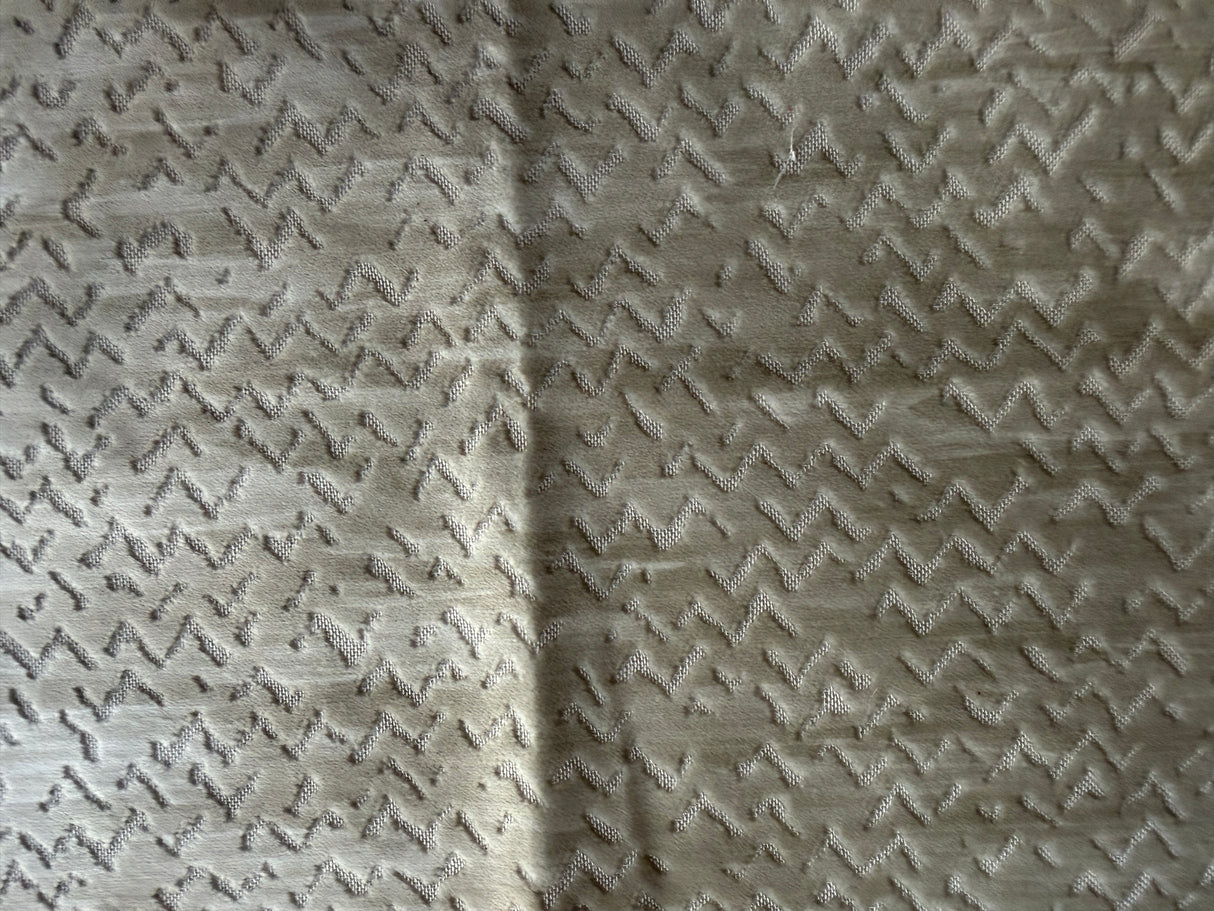 Textured fabric with a subtle pattern on a beige background