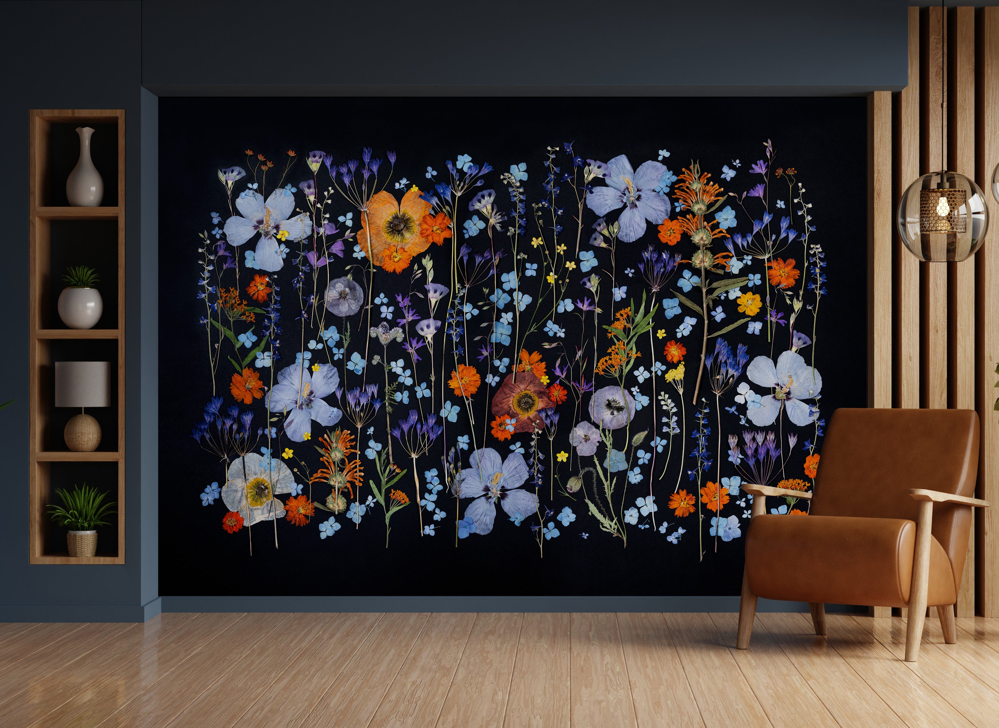 Wall mural of colorful flowers on a black background in a room with a brown armchair and wooden shelves.