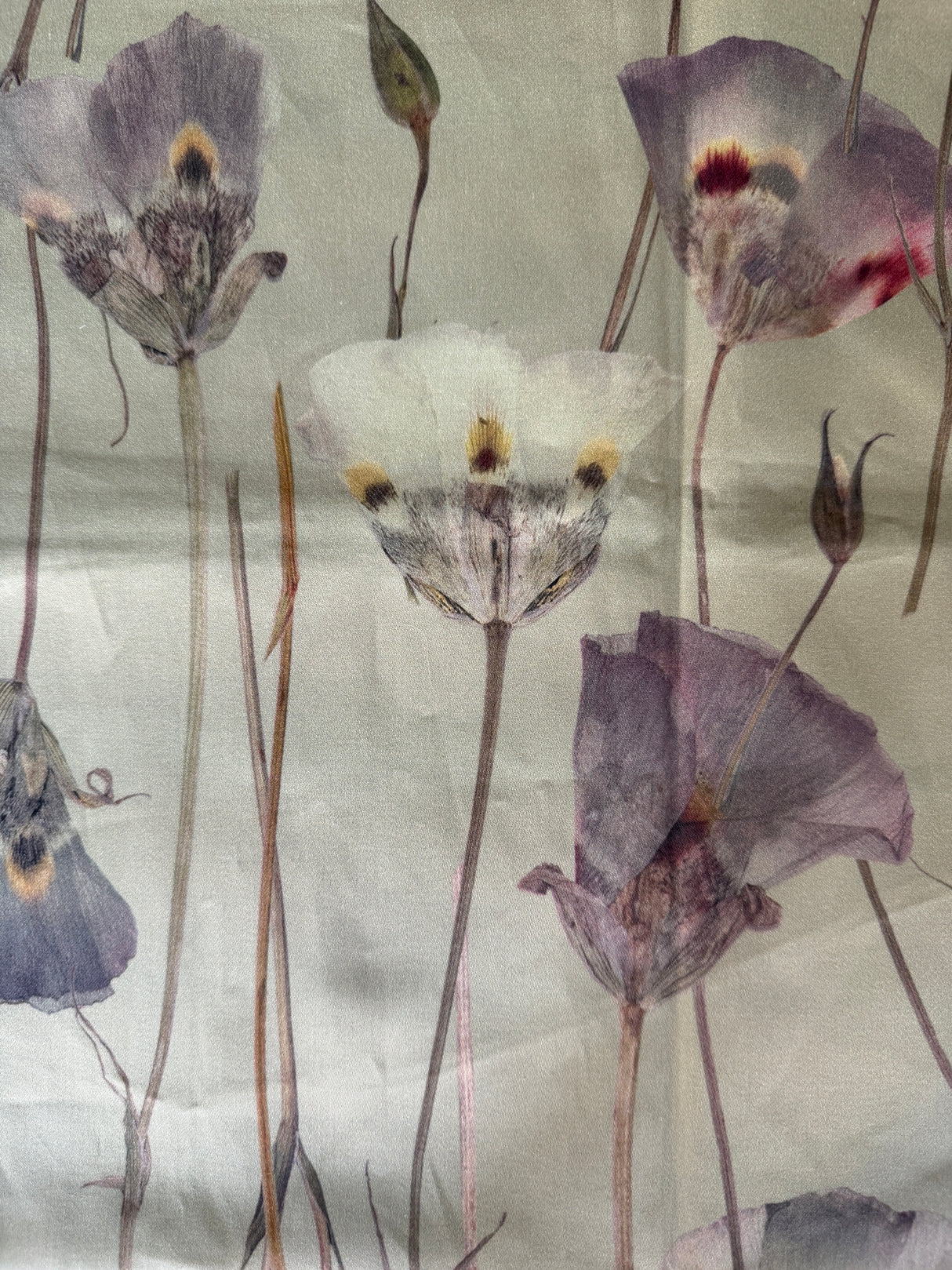 Pattern of wilted flowers on a textured fabric background