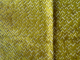 Close-up of a textured yellow fabric with a subtle pattern