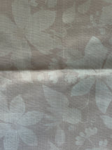 Textured fabric with leaf pattern in pink tones