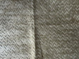 Textured fabric with a subtle pattern on a beige background