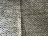 Textured fabric with a subtle pattern on a beige background