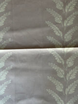 Fabric with leaf pattern on a mauve background