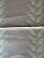 Fabric with leaf pattern on a mauve background