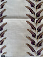Fabric with purple leaf pattern on a white background